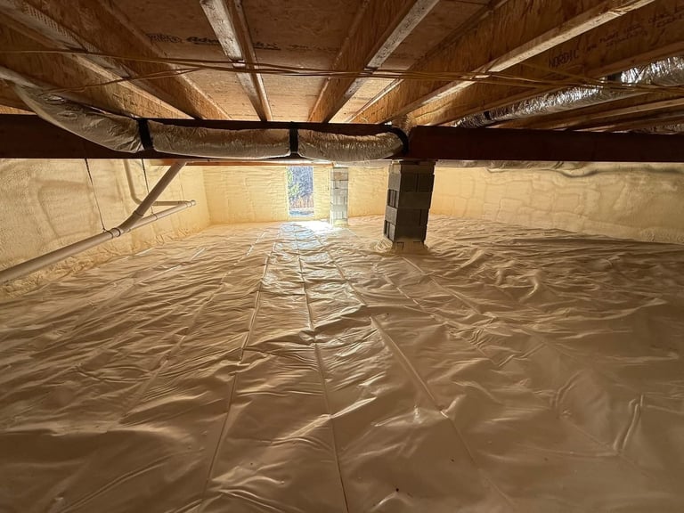 Crawlspace interior with plastic vapor barrier covering floor, wooden beam supports, and light visible through window opening